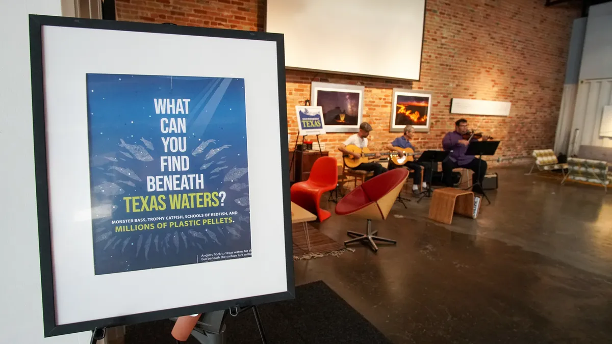 A framed Texas environmental poster at an indoor gathering